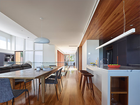 Kitchen and living area with Breezway louvres in Nundah house